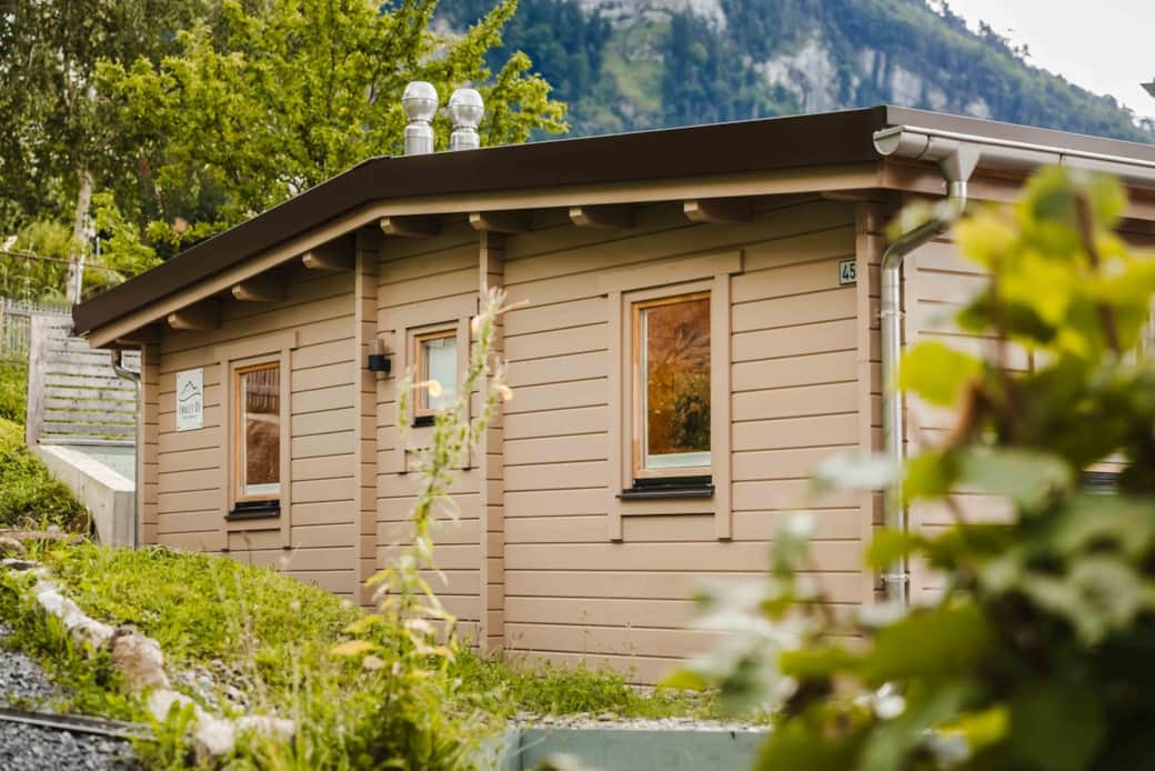 Exterior of Chalet Oz wooden chalet surrounded by greenery in Vitznau Exterior of Chalet Oz wooden chalet surrounded by greenery in Vitznau