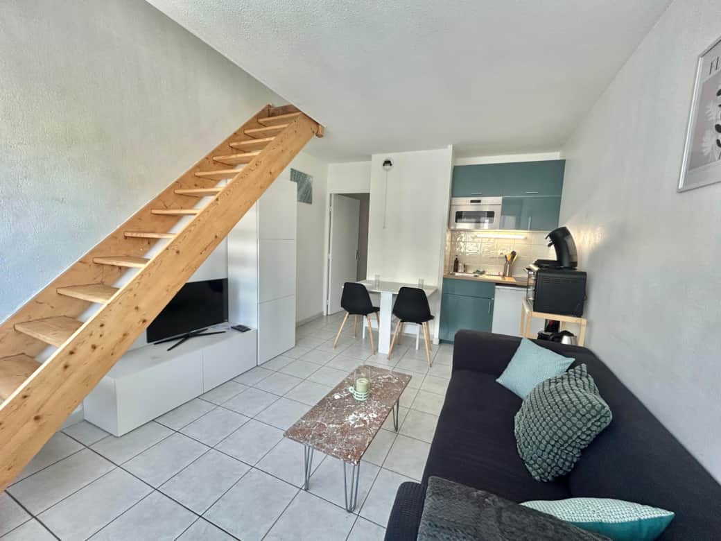 Living room, sofa, dining table, chairs, lamp, coffee table, kitchen, micro wave, TV, stairs