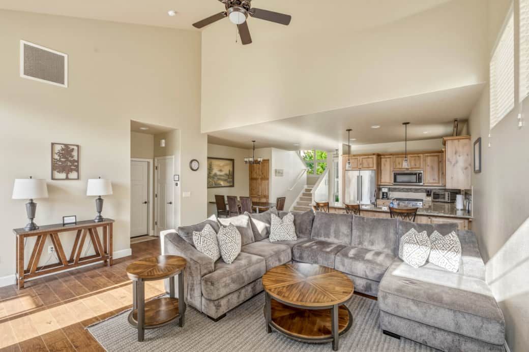 Open-concept great room with vaulted ceilings, hardwood floors, and gourmet kitchen.
