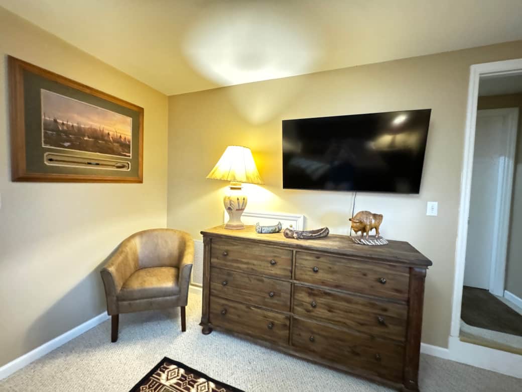 Basement Bedroom with Reading Chair & Dresser