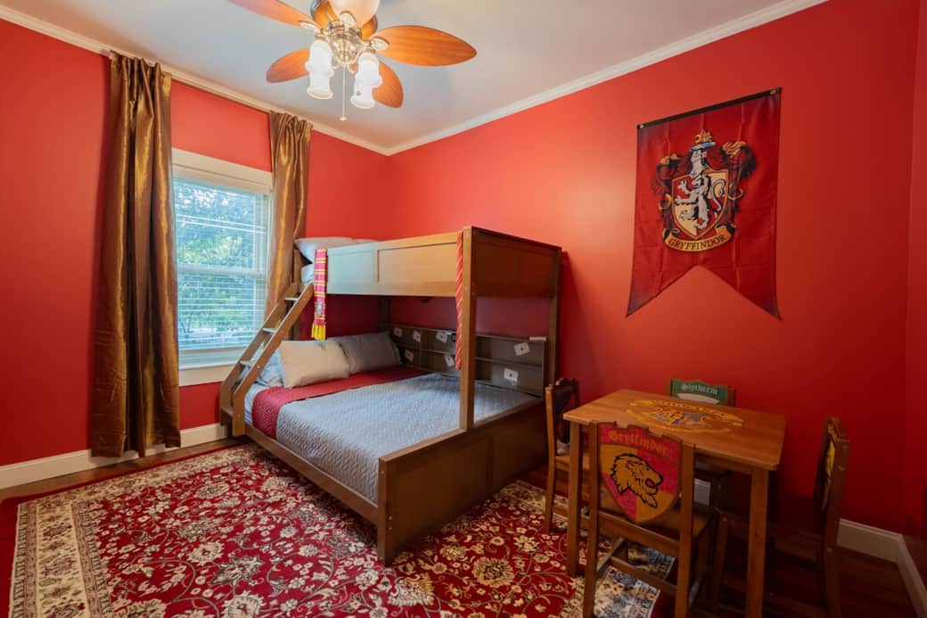 The Gryffindor Common Room! Cozy up with Harry, Ron, and Hermione! Get comfortable on the queen bed, or let the top bunk twin bed be your very own wizarding perch for a magical rest. The Gryffindor Common Room! Cozy up with Harry, Ron, and Hermione! Get comfortable on the queen bed, or let the top bunk twin bed be your very own wizarding perch for a magical rest.