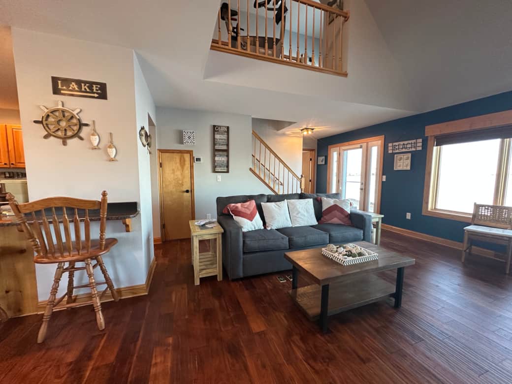 Curl up fireside in the spacious living room, complete with plush sofas and lake views just beyond the windows or watch the 65 inch tv. Curl up fireside in the spacious living room, complete with plush sofas and lake views just beyond the windows or watch the 65 inch tv.