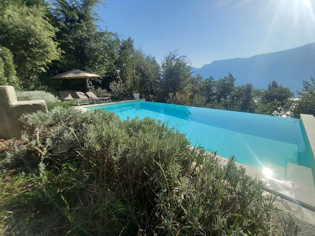 Saltwater infinity pool overlooking Lake Garda and mountains at Villa Mare di Luci