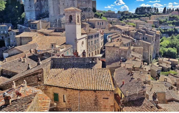 Sorano medieval hill town with the Orsini Fortress above the valley in southern Tuscany, Italy