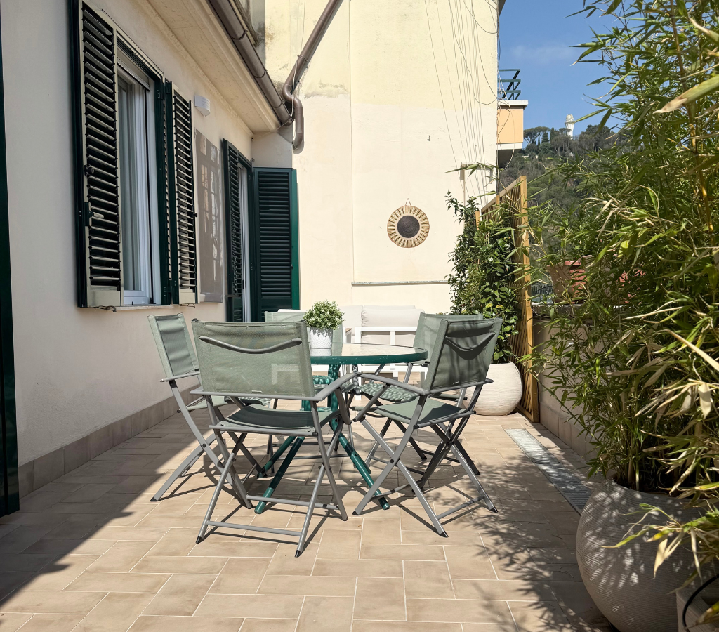 Large private terrace with dining table and lounge area.