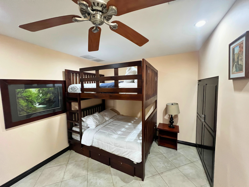 A restful setup with roomy queen bunk beds—ideal for kids or adults.