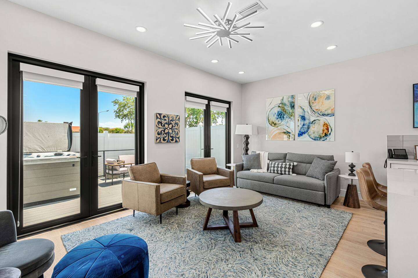 Relax in this spacious living room with plenty of natural light and modern furnishings.