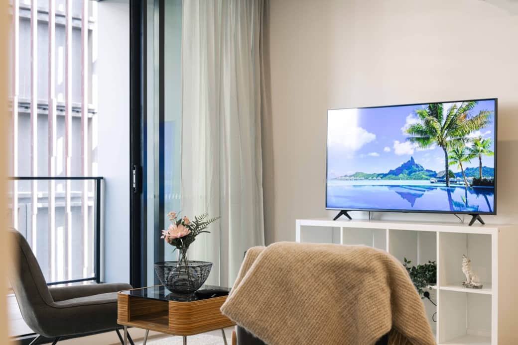 Curl up in our cozy TV corner, where  comfortable chairs  await. The large flat-screen TV offers endless entertainment options, and the view of the window adds a touch of nature to your indoor relaxation. where is ideal spot for movie nights.