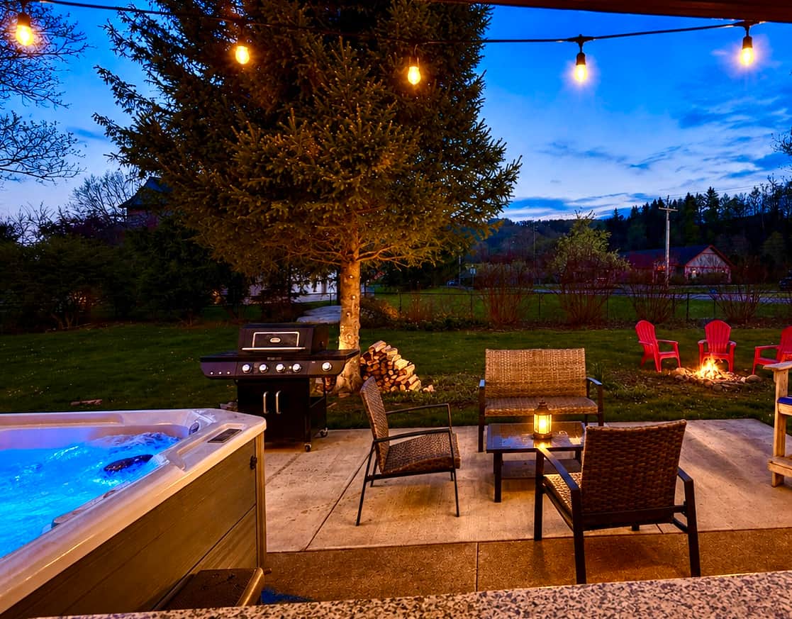 Relax under the lights with hot tub views, firepit ambiance, and mountain views and atmosphere.