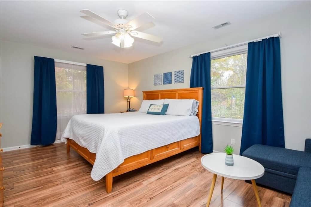 Light Wood King bedroom, sleeper sofa, chaise sectional, natural light, Navy room darkening curtains, coastal modern, family-friendly, sleeps 3+.