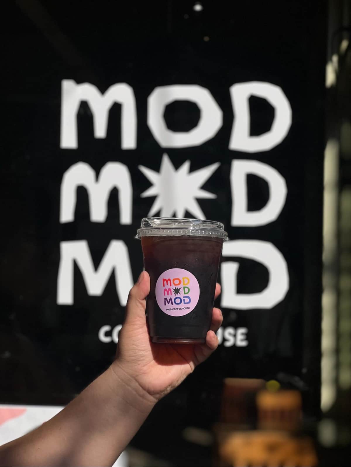 Iced coffee on a wooden table at Mod Coffeehouse in Galveston