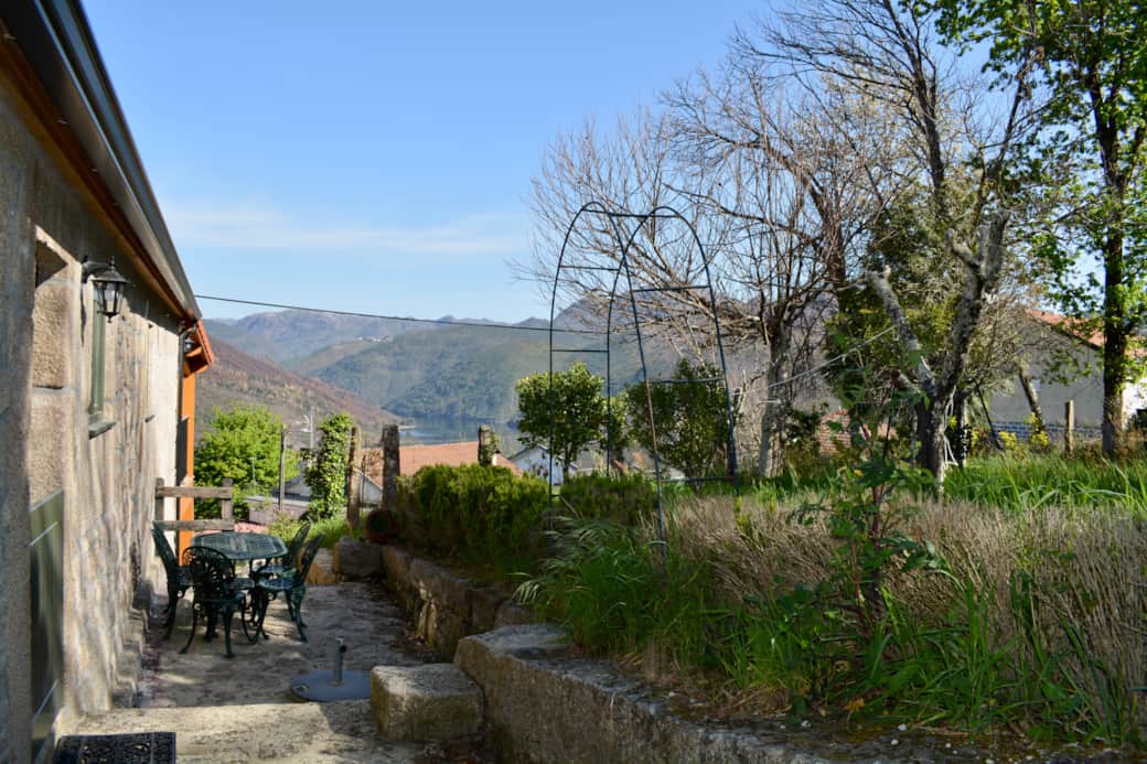 The cottage is seamlessly integrated into the lush landscape of the national park.