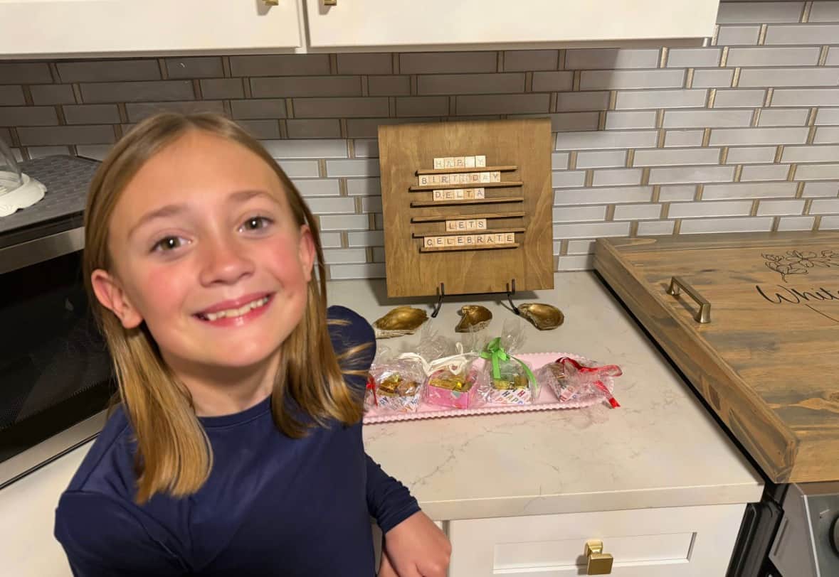 Birthday gifts set out on the kitchen island at White Magnolia Galveston as part of a birthday welcome setup