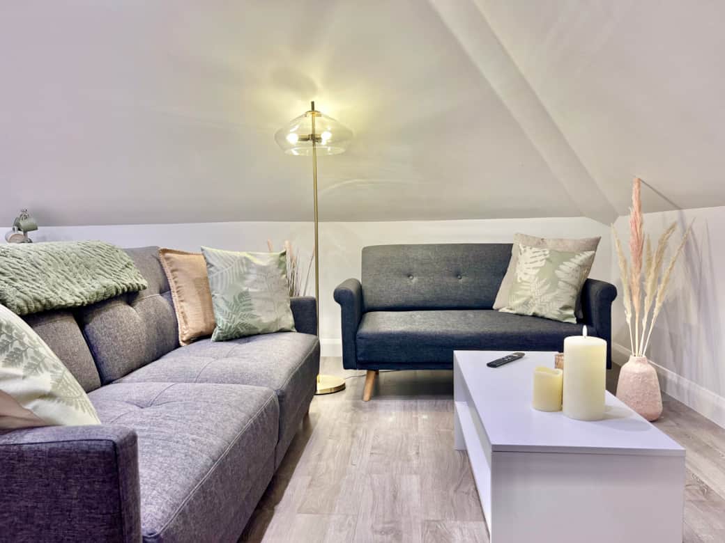 Living Room: Stylish seating and soft lighting create a perfect spot to unwind and relax!