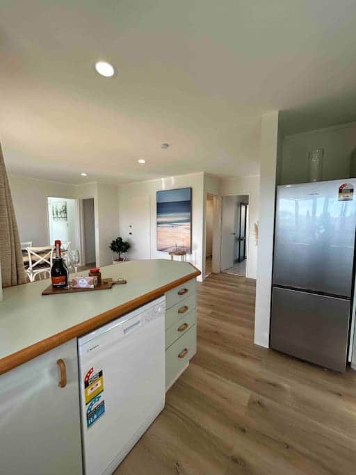Spacious and social kitchen with a view to the dining area with generous bench space.