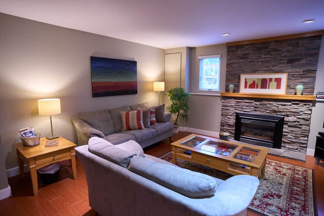 Relax in our cozy, spacious living room with gas fireplace and flatscreen TV Relax in our cozy, spacious living room with gas fireplace and flatscreen TV