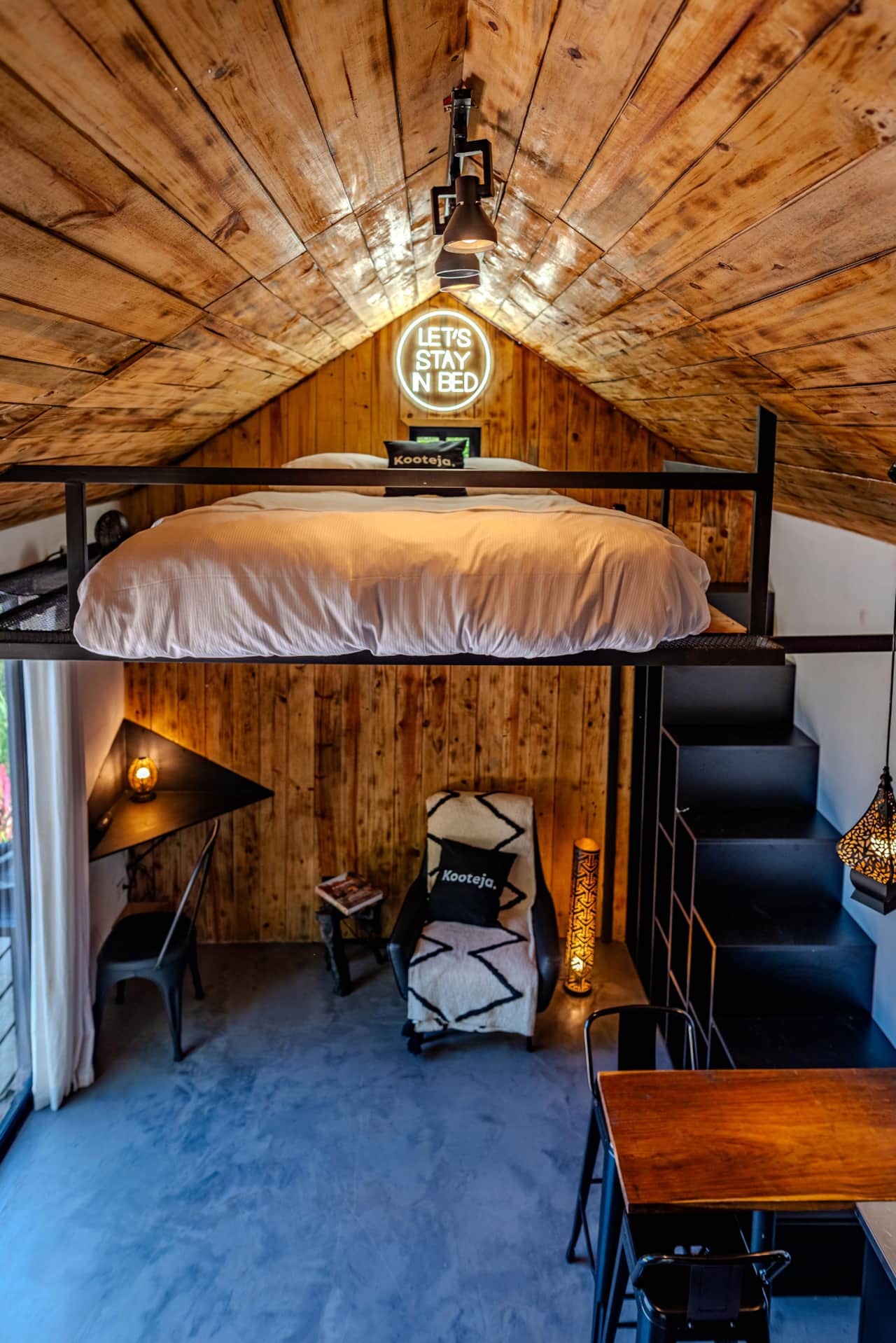 Cozy lofted bed beneath the pine ceiling of our Scandinavian tiny house in Valle de Antón