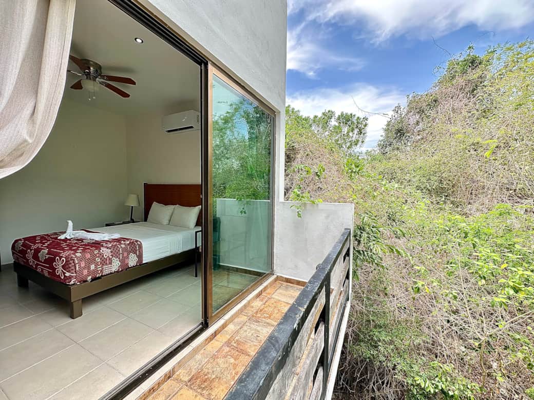 Bedroom with queen size bed and en-suite bathroom and shared balcony