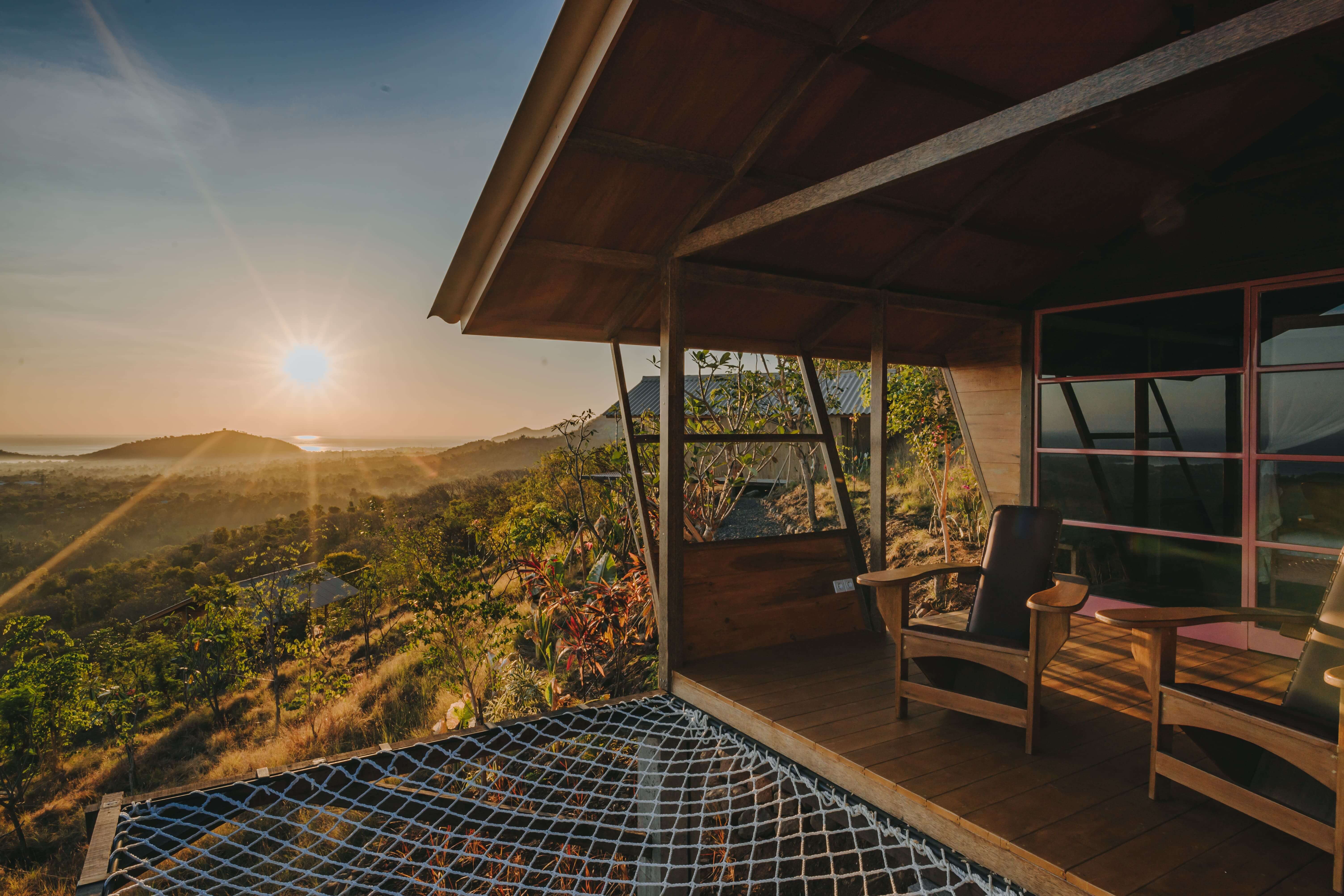 Rustic cabin surrounded by lush greenery