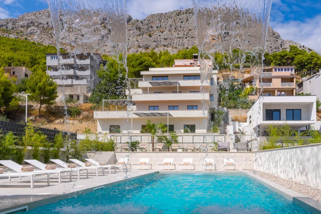 ALMISSUM Residences Pool and Facade Framed by Waterfall
