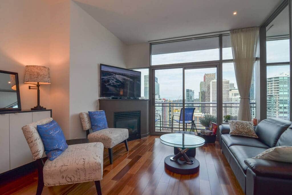 Spacious living room with flatscreen TV and beautiful city views