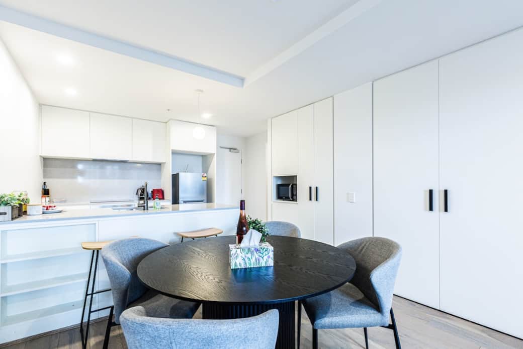 The dining area, adjacent to the modern kitchen, offers a cozy and inviting space for meals. With stylish furniture and a well-lit environment, it’s perfect for dining with family or friends, and  ensures a welcoming atmosphere for all.
