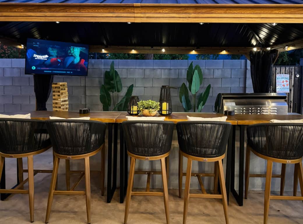 Watch a game or movie, enjoy a drink, or fire up the grill at this covered outdoor bar with seating for 6 and a large TV.