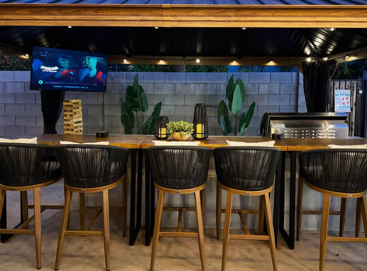 Watch a game or movie, enjoy a drink, or fire up the grill at this covered outdoor bar with seating for 6 and a large TV.
