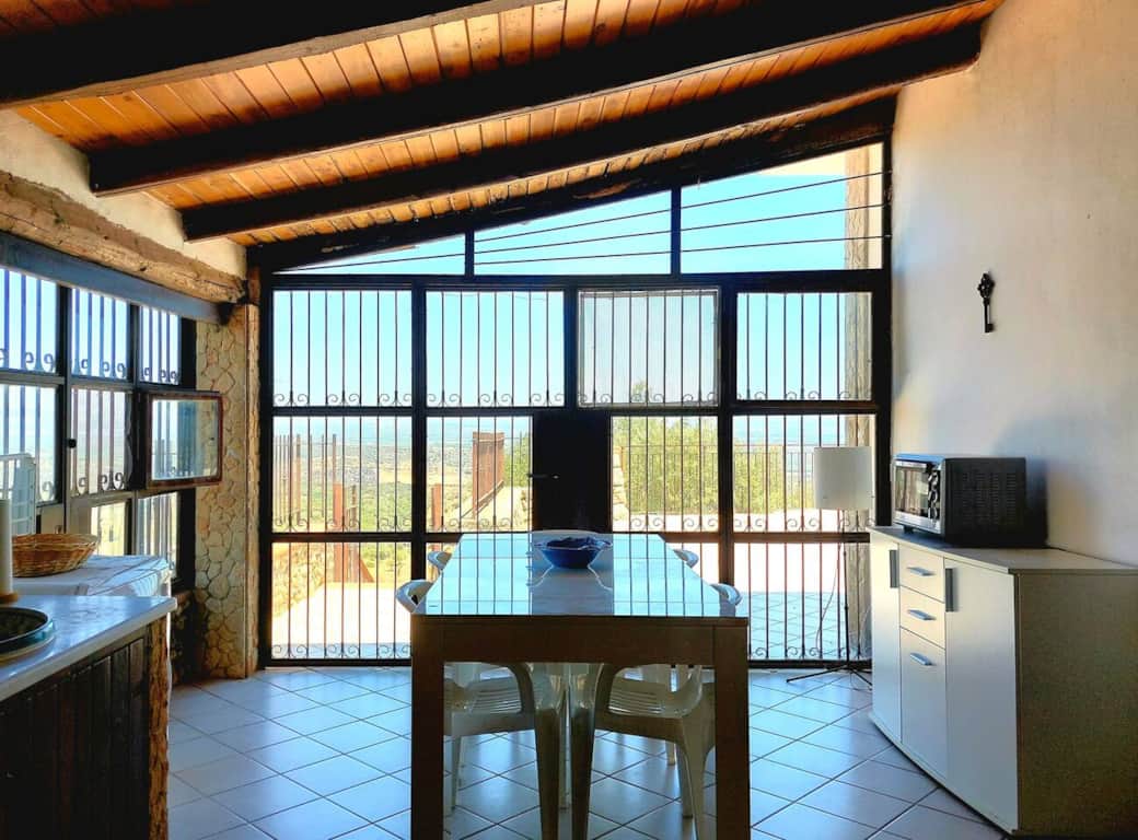 The kitchen, with a large window, opens onto the panoramic terrace.