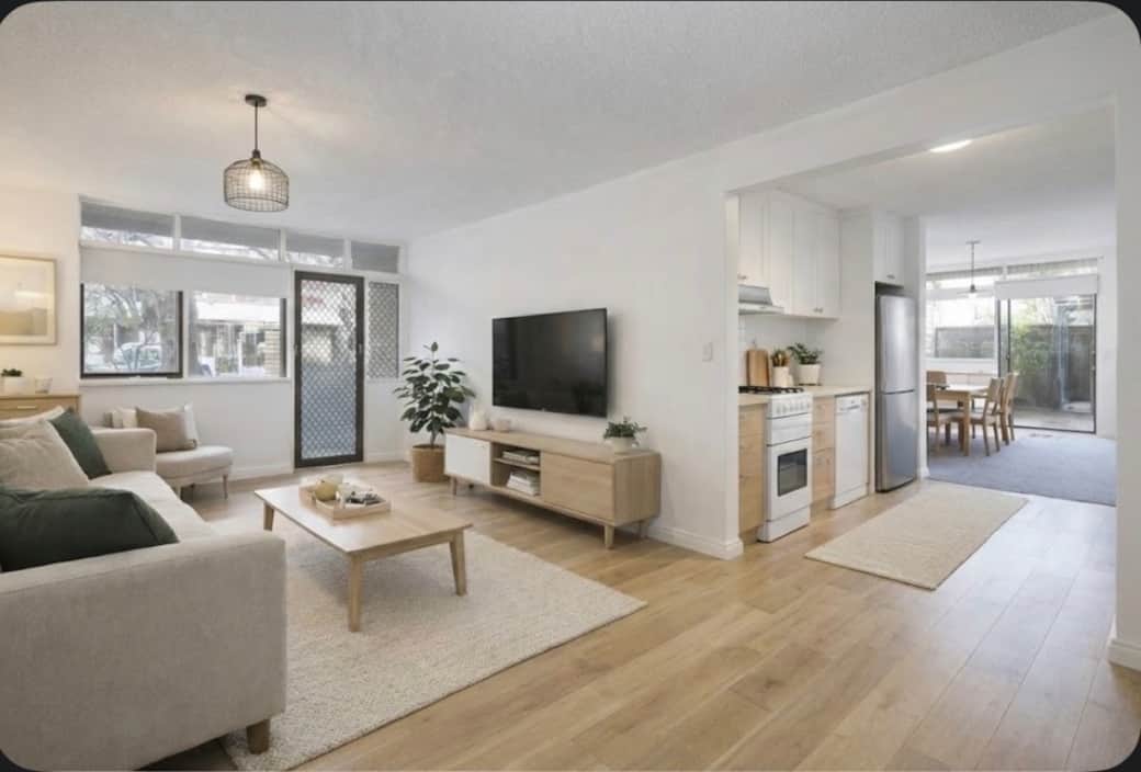 Bright, open-plan living with a big-screen TV and a calm, modern vibe—perfect for switching off after a long day