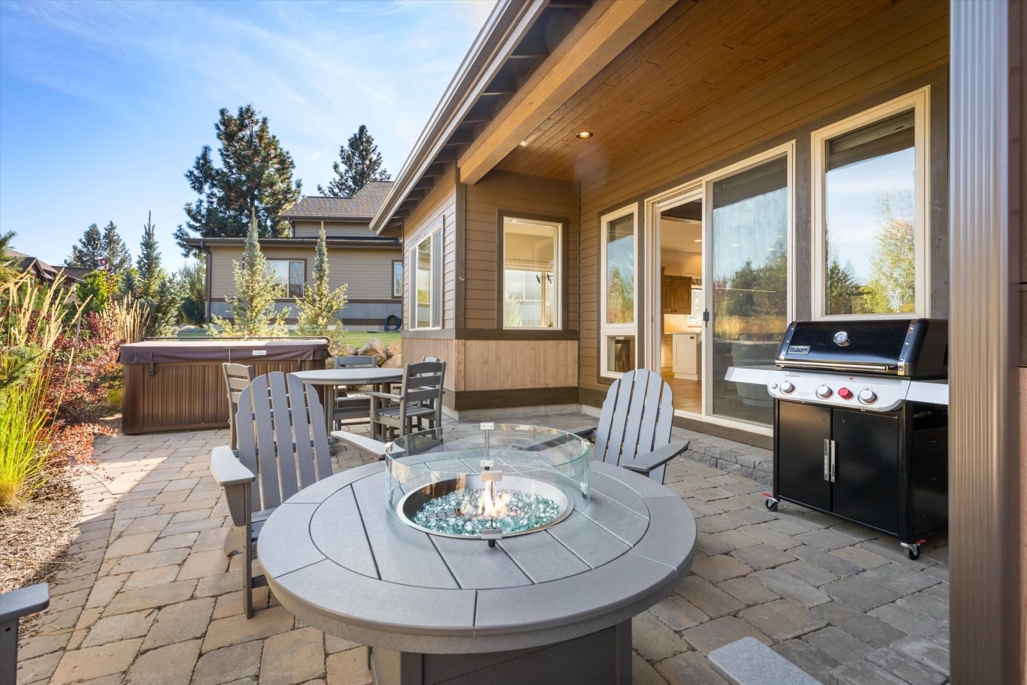 Hot tub, fire table, and outdoor dining on the back patio