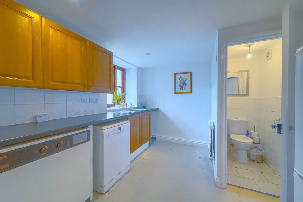 Utility room with washing machine, sink, downstairs toilet
