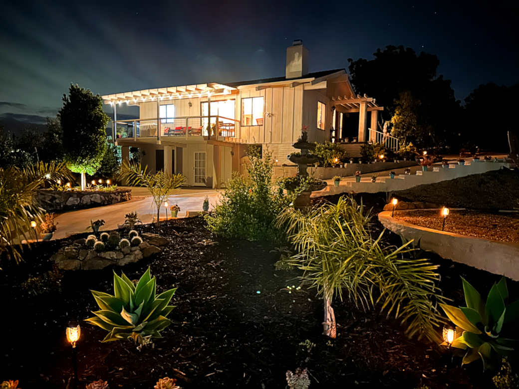 Penthouse Cottage (top floor) and Grove View Suite (ground floor) by night.