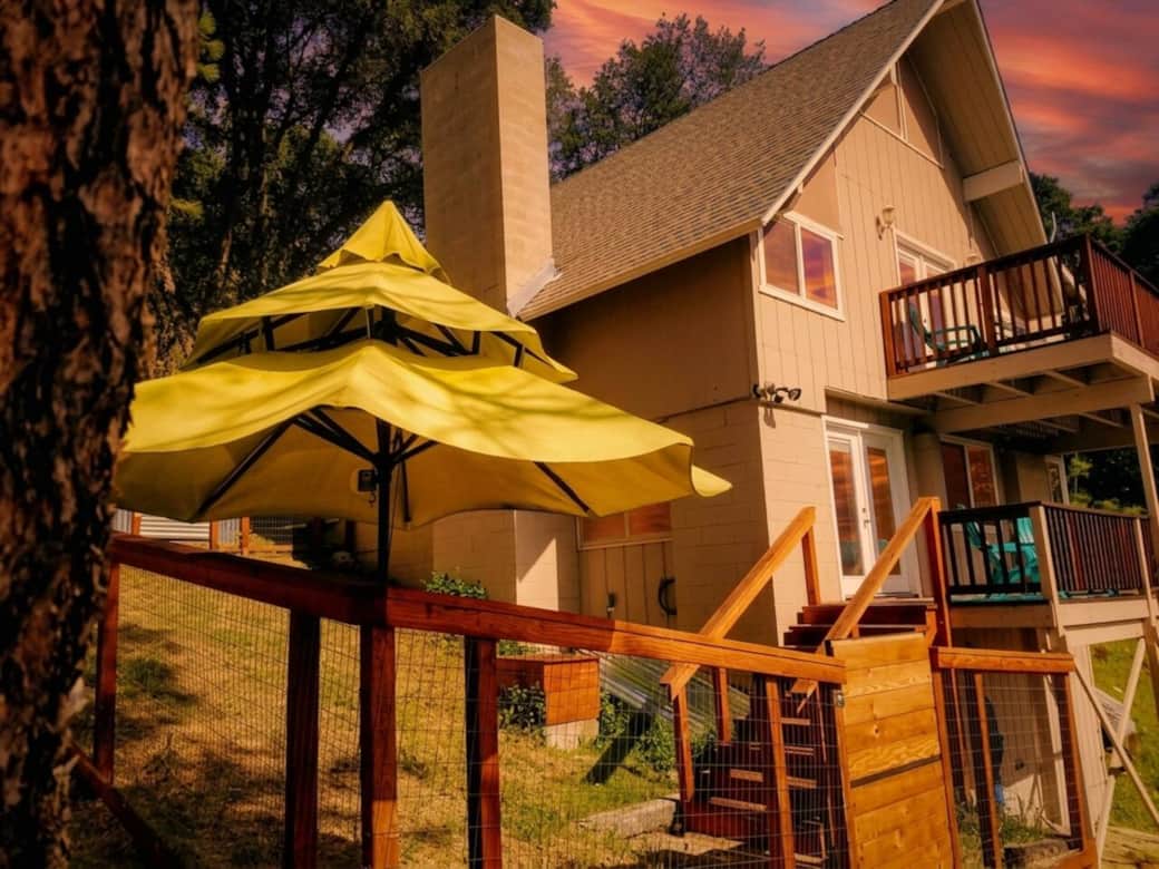Welcome to your mountain cabin retreat — multiple decks perfect for sipping wine under the sunset sky