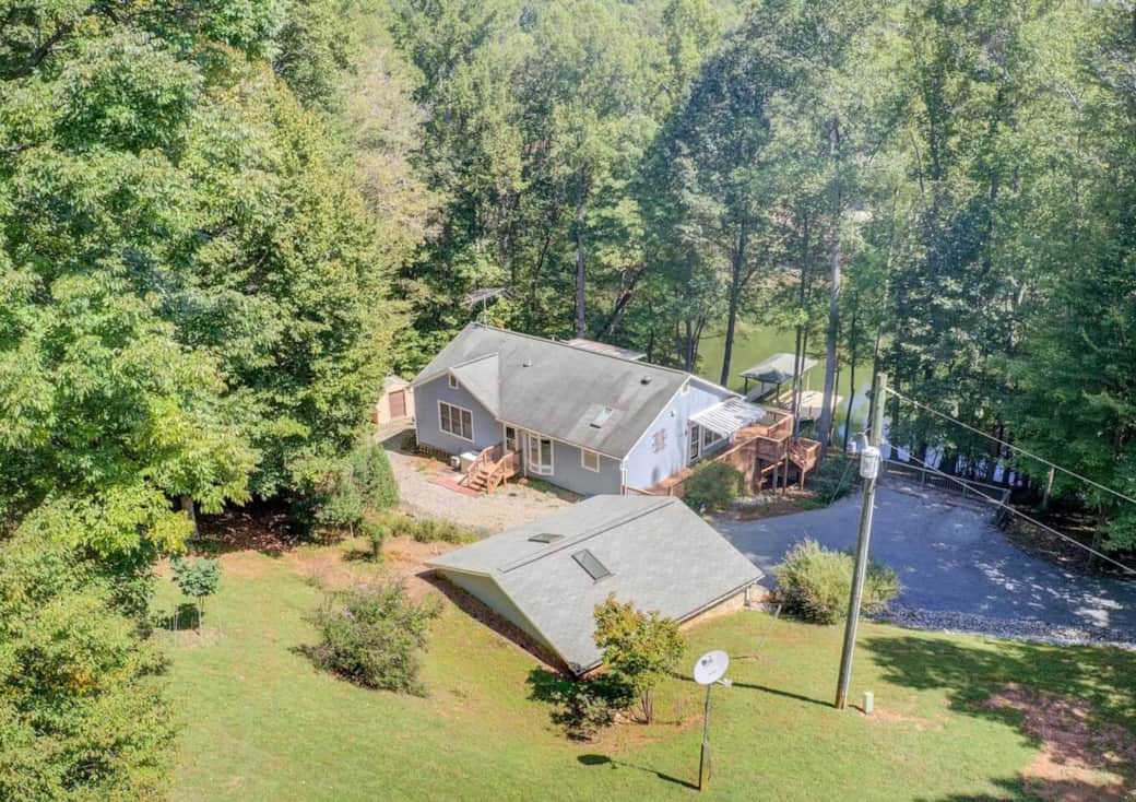 Private lakefront home on 5 wooded acres, offering a peaceful setting with easy access to the dock and water.