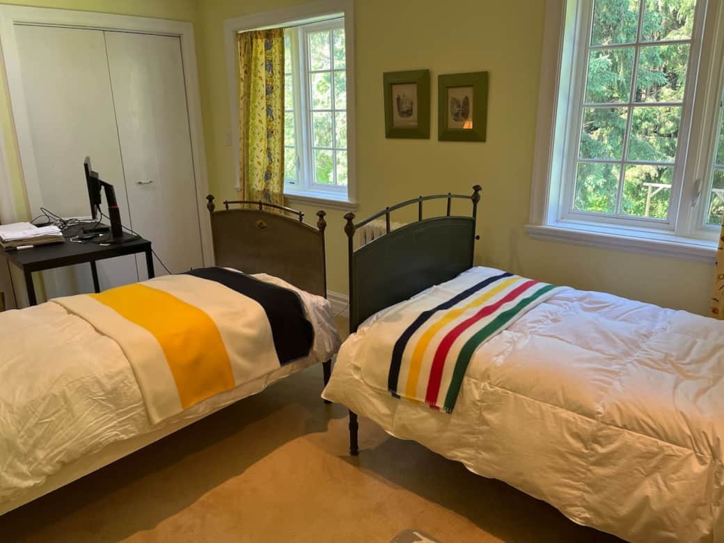 Twin beds featuring elegant 19th century Austrian beds, configured for  modern day use. Lockable from the inside. Shared full bathroom adjacent