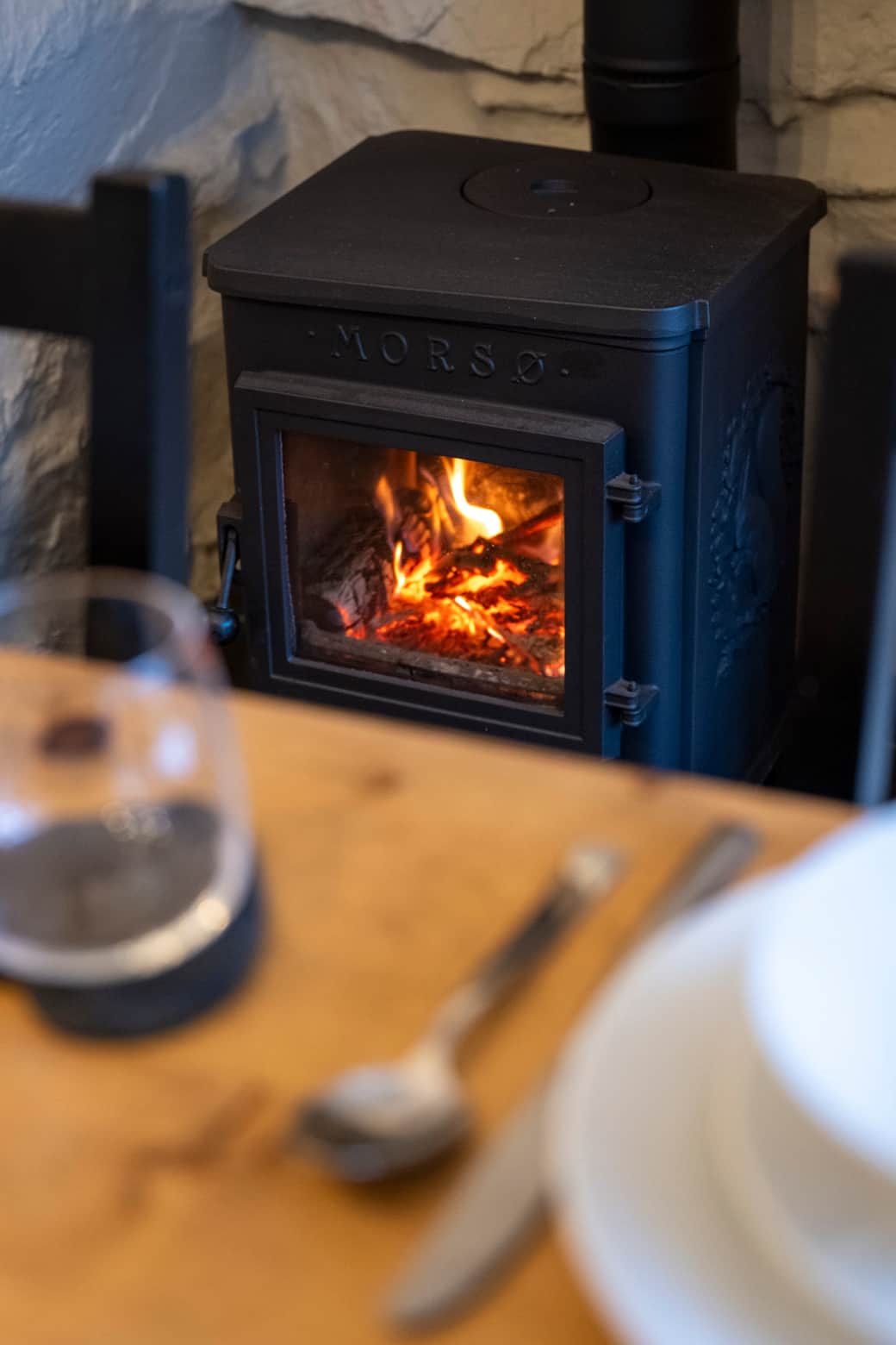 Eveneing dining with a crackling log burner and a glass of wine by the fire Eveneing dining with a crackling log burner and a glass of wine by the fire