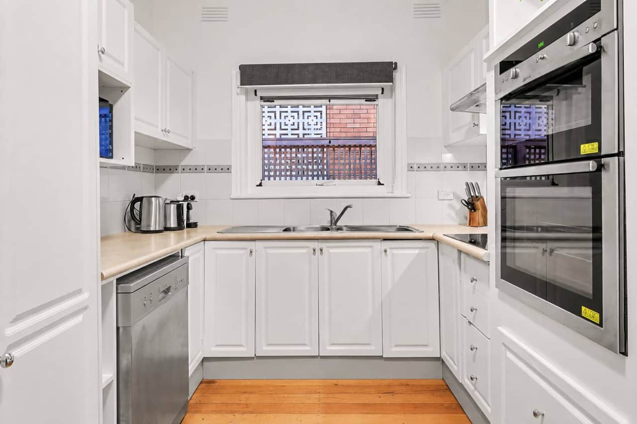 Full kitchen with generous cabinetry, dishwasher, double oven and bench space, suited to guests who plan to cook regularly during an extended stay.