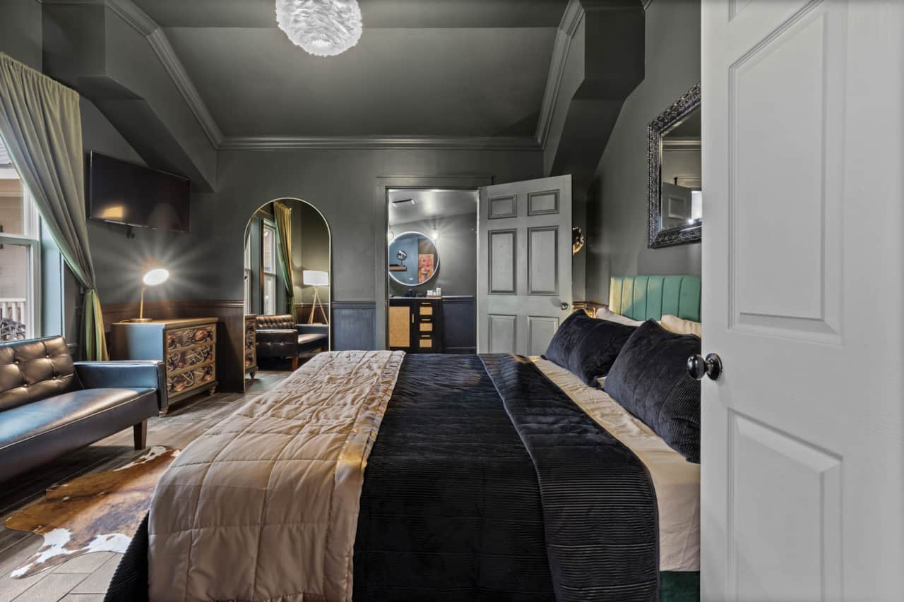 Spacious king suite with futon sofa sleeper leading into bath