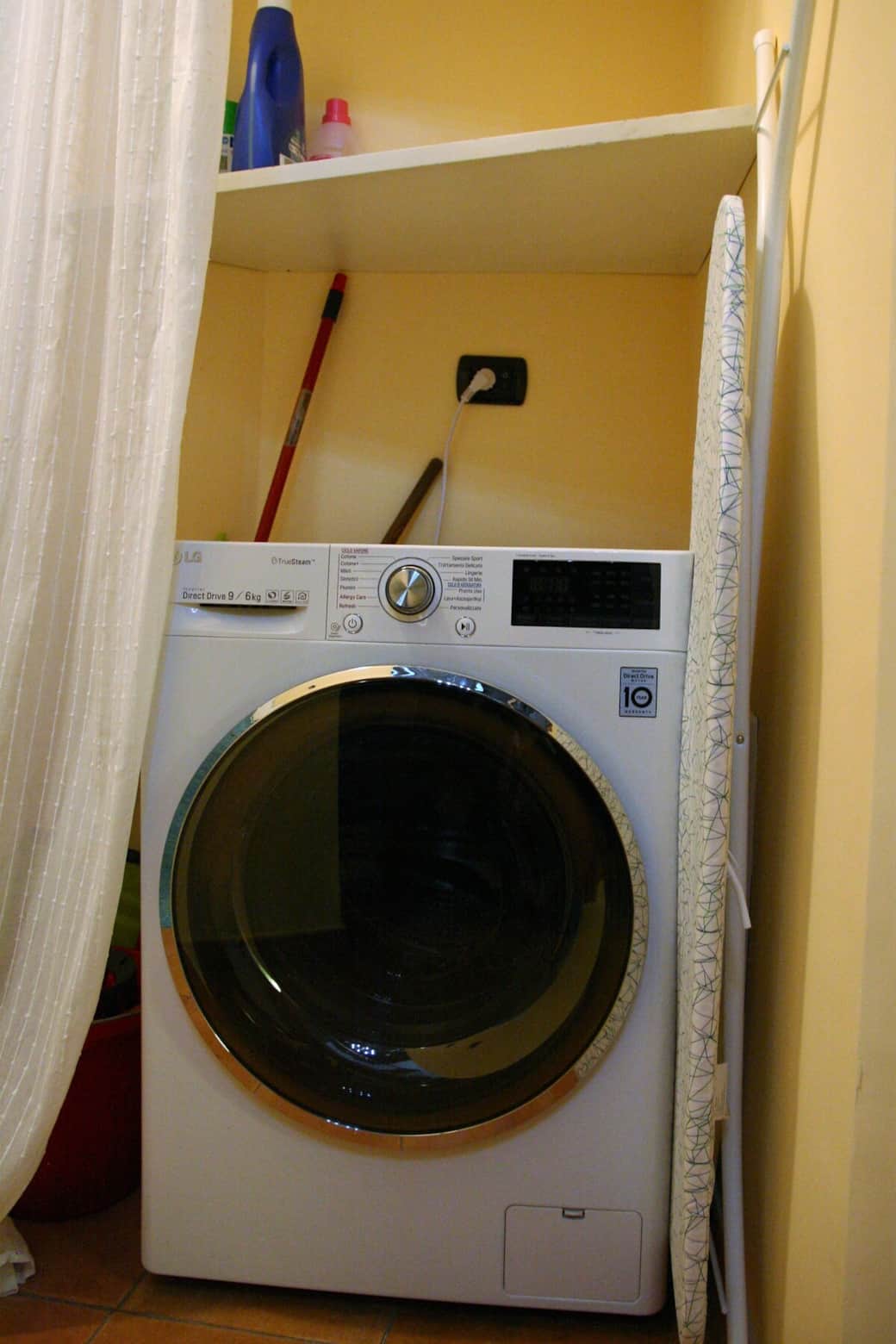washing and drying machine in the small corridor between the living room and the main bedroom