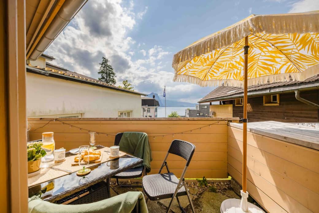 Private balcony view with breakfast setup overlooking Lake Lucerne Private balcony view with breakfast setup overlooking Lake Lucerne
