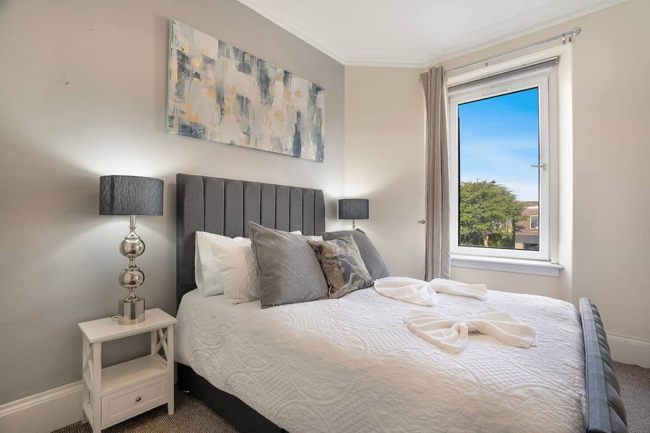 A quiet, light-filled bedroom arranged for comfort and rest, ideal after busy workdays or long journeys.