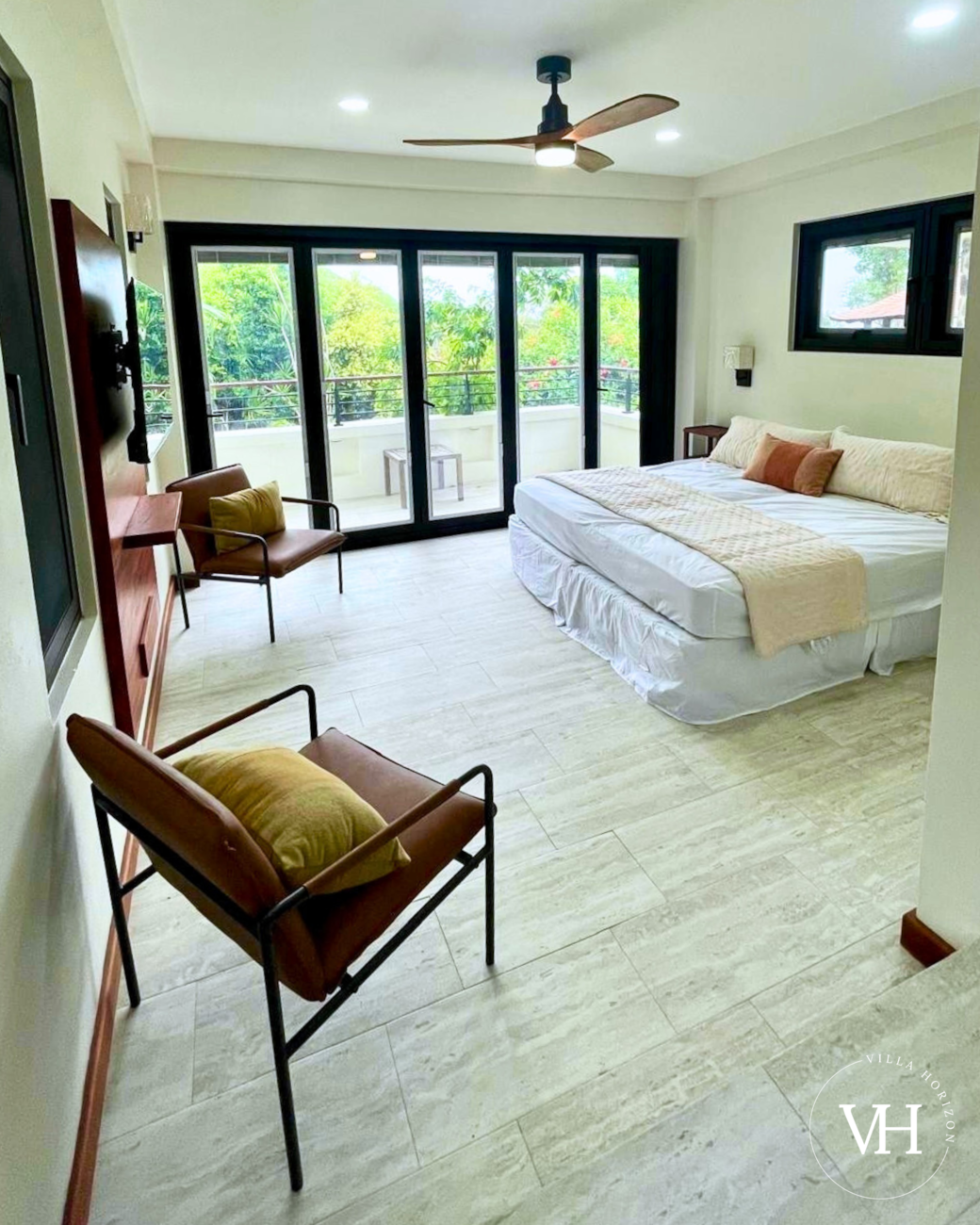 Bedroom with king bed that can convert into two twin beds, smart TV, comfy seating, and board games.
