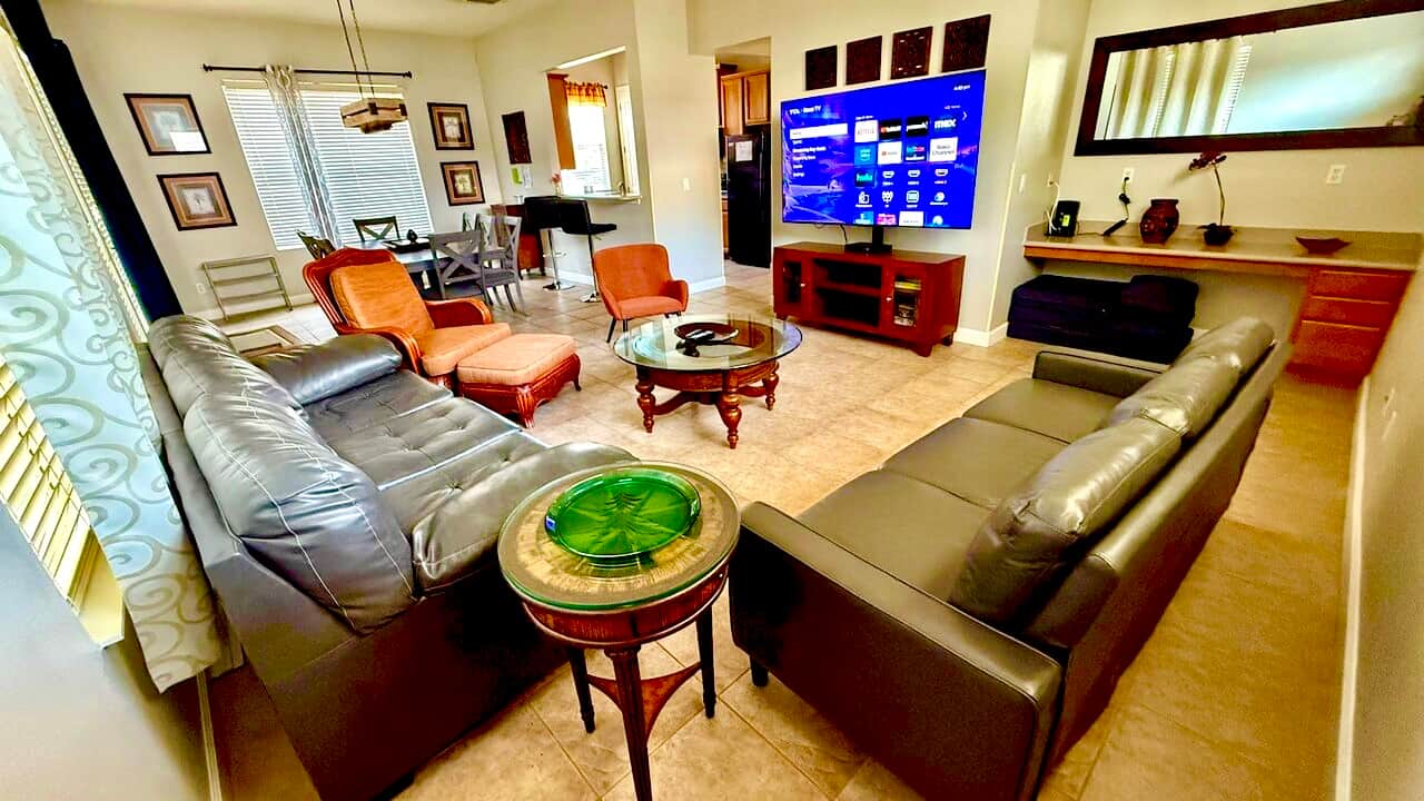 Main living space with plenty of seating an large TV