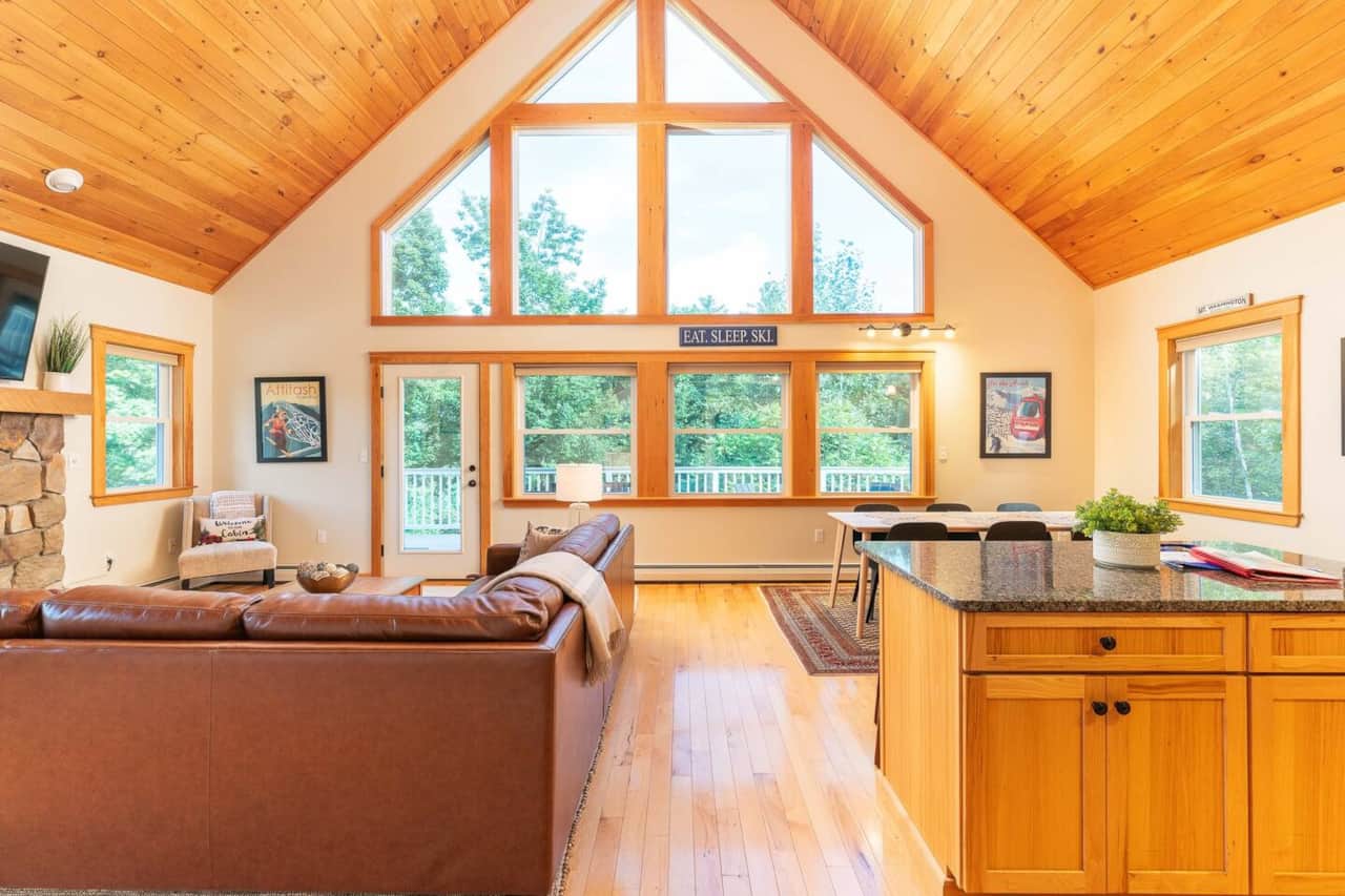 Main open concept living area with natural pine ceilings and hardwood floors