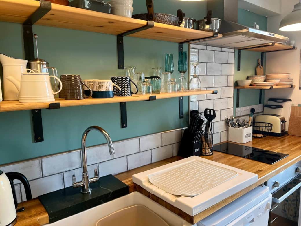 The kitchen area has an oven,  electric hob,  microwave, toaster, kettle, fridge with freezer compartment, dishwasher, cooking utensils, cutlery, crockery & glassware, cooking dishes and baking sheets 