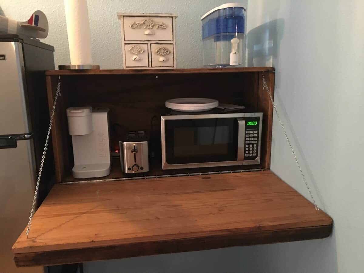 A vintage box for the microwave, coffee maker, and toaster! With a water supply of filtered water for guests' convenience.