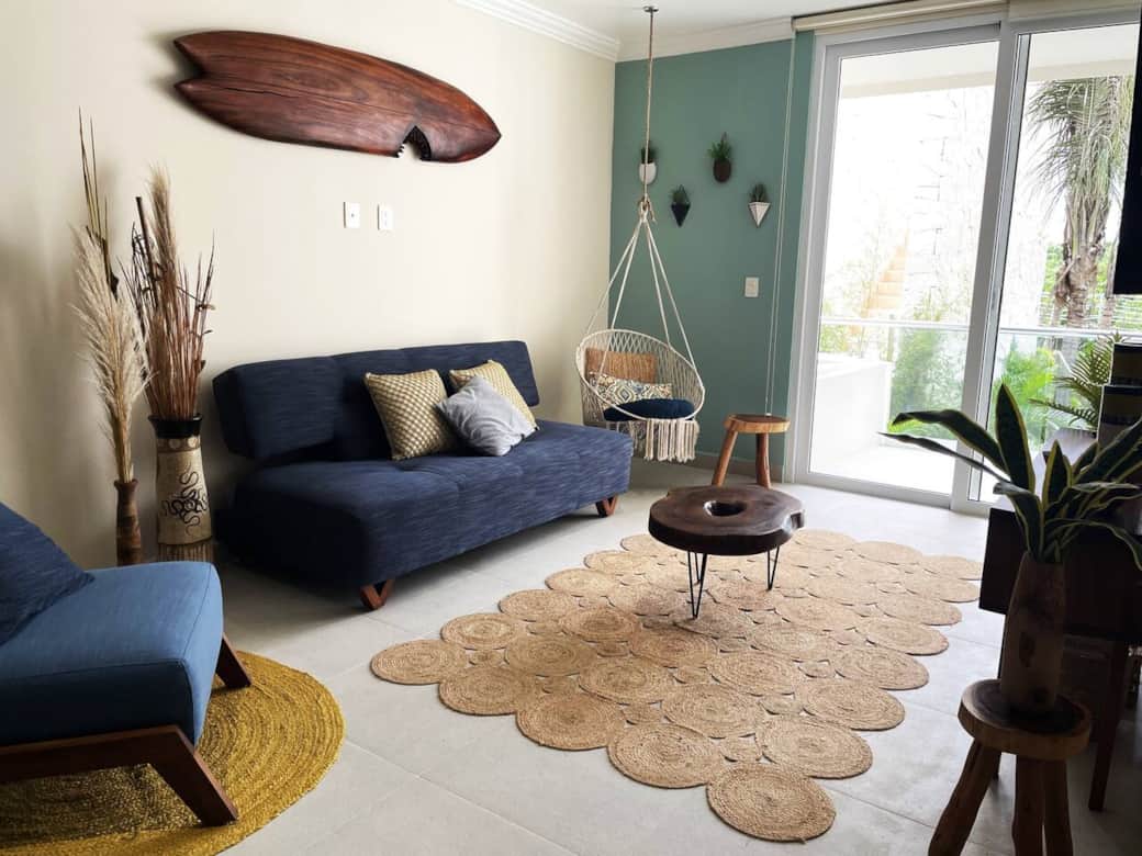 Relax in style: Our inviting living room features a TV, a cozy sofa bed, and a coffee table, all framed by a mesmerizing view of the lush jungle garden. A perfect blend of comfort and nature awaits in this tranquil oasis.