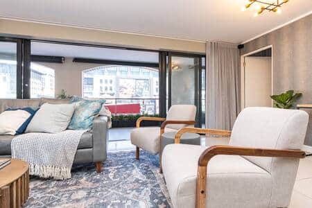 A stylish and spacious living room with modern furnishings and abundant natural light. A stylish and spacious living room with modern furnishings and abundant natural light.