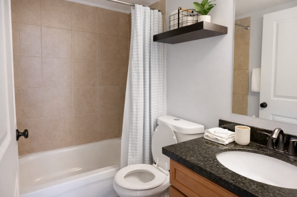 Bright, minimalist bathroom featuring a  tub and all the essentials thoughtfully stocked.